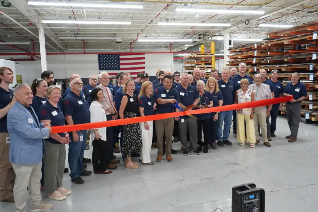 The staff of Chapco, Inc. cut a red ribbon to mark the opening of their new manufacturing center at 12 Bridge St. Deep River, CT 06417