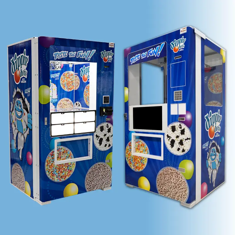 Two blue Dippin' Dots vending machines with colorful snack graphics and the 'Taste the Fun!' slogan, side by side in a bright setting.